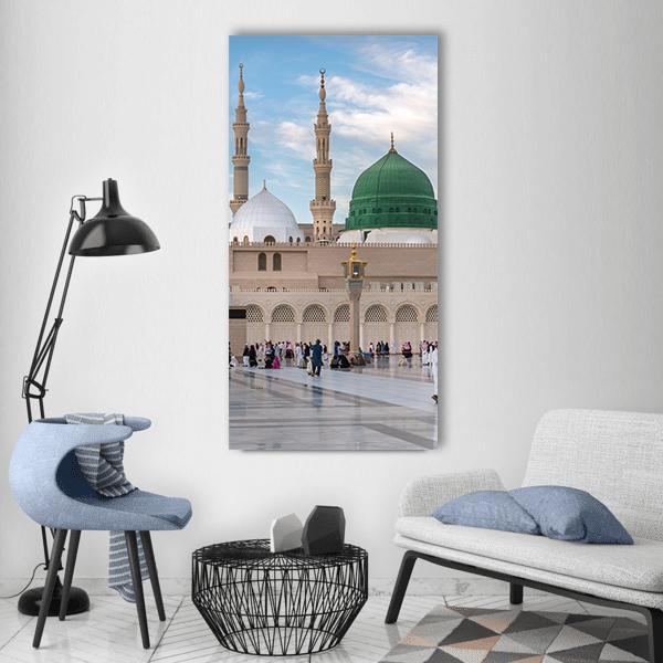 Prophet's Mosque in Medinah Vertical Canvas Wall Art in beige, green and blue, single vertical panel hung on a wall