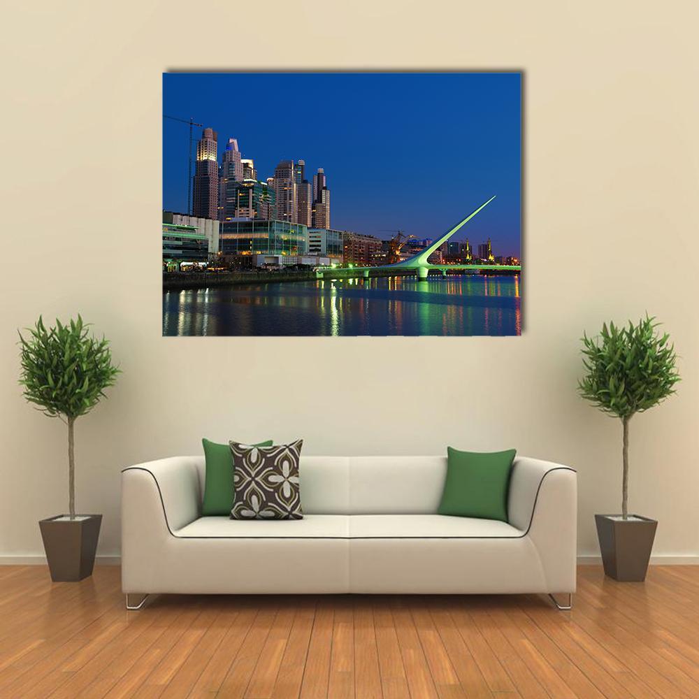 Puente De La Mujer Night Skyline Canvas Wall Art in black, yellow and blue, single panel hung on a wall