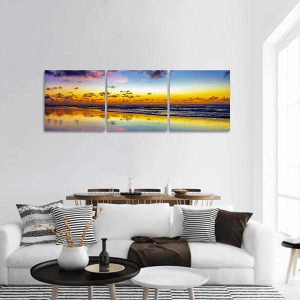 Purple Twilight Over Brazilian Beach Panoramic Canvas Wall Art in yellow, blue and purple, hung on a wall