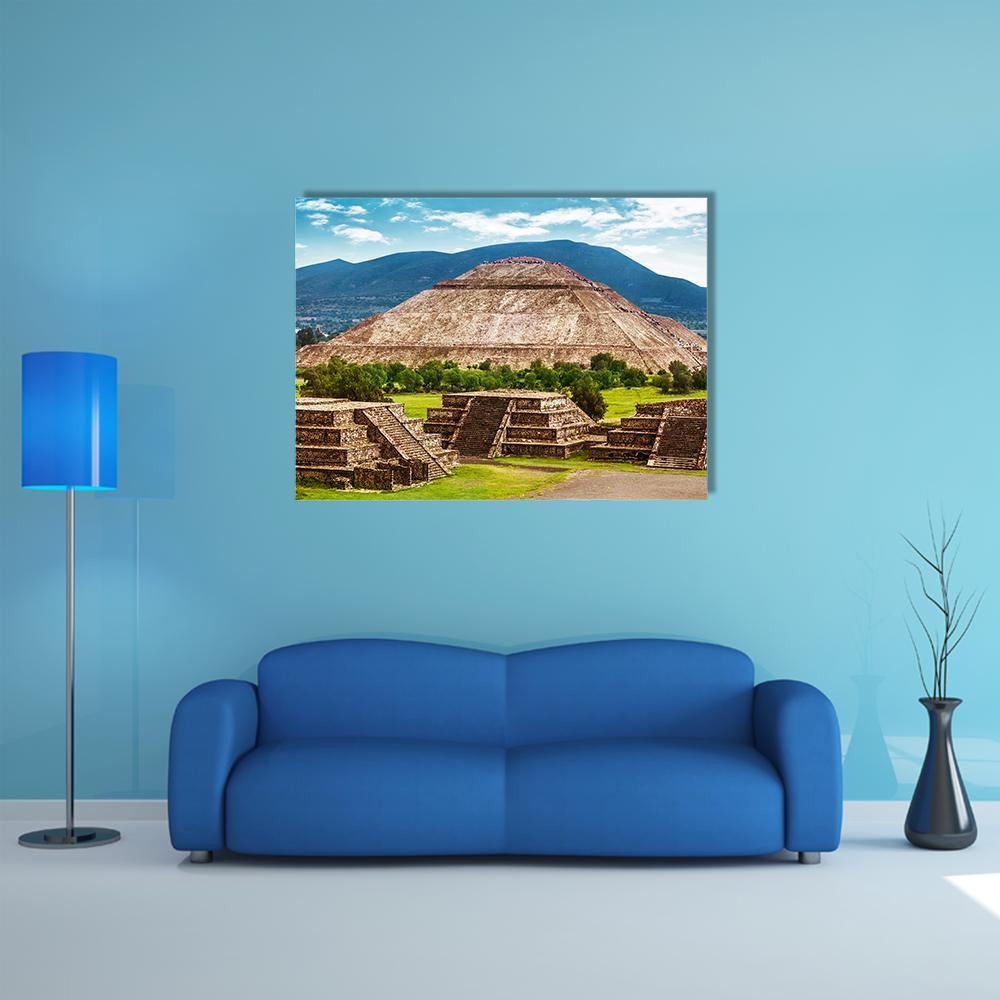 Pyramid of the Sun and Moon, Teotihuacan Canvas Wall Art in brown, green and blue, single panel hung on a wall