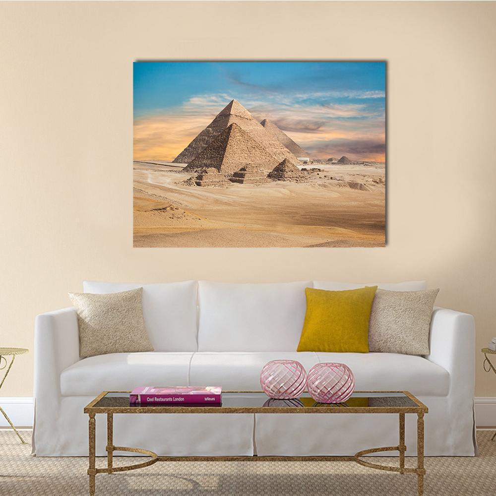 Giza Pyramids at Sunset Canvas Wall Art in beige, orange and blue, single panel hung on a wall
