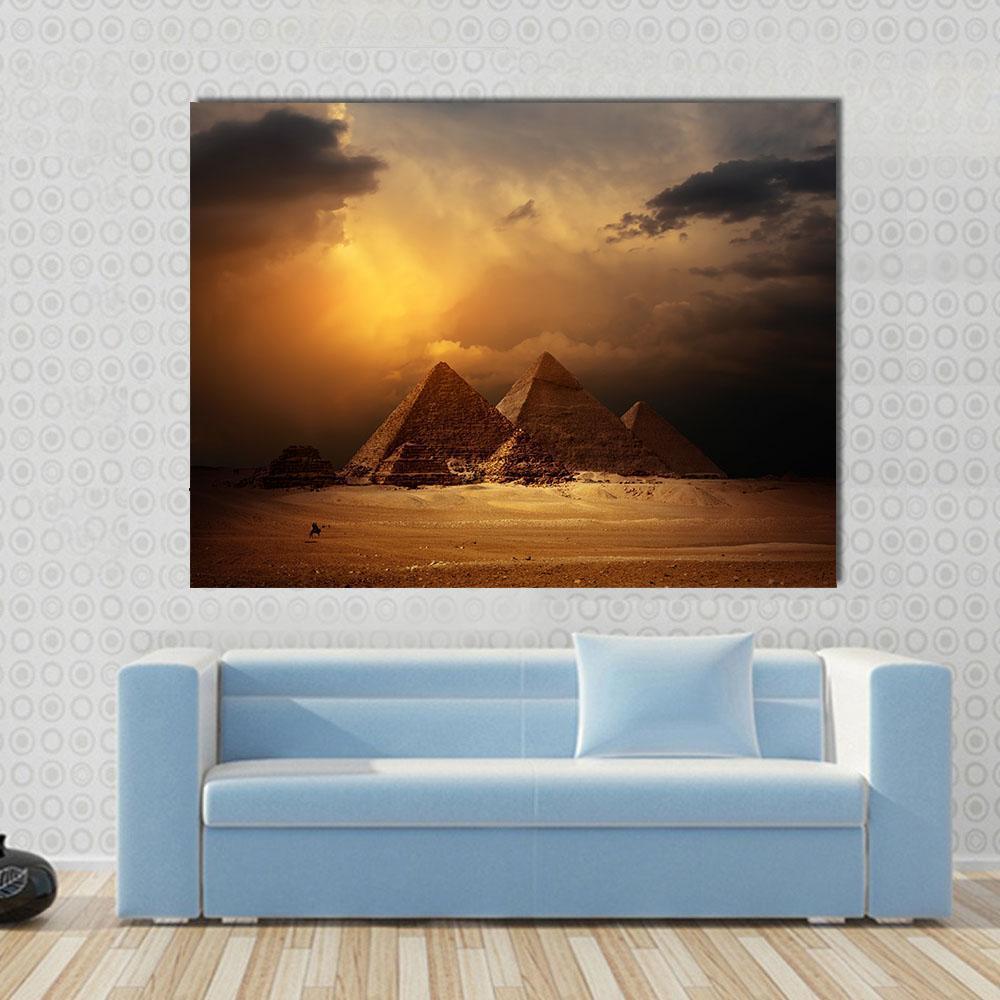 Pyramids in Giza Valley Under Dark Clouds Canvas Wall Art in black, brown and yellow, single panel hung on a wall