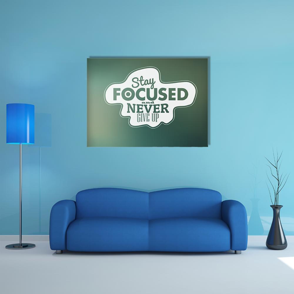 Stay Focused and Never Give Up Quote Canvas Wall Art in white and green, single panel hung on a wall