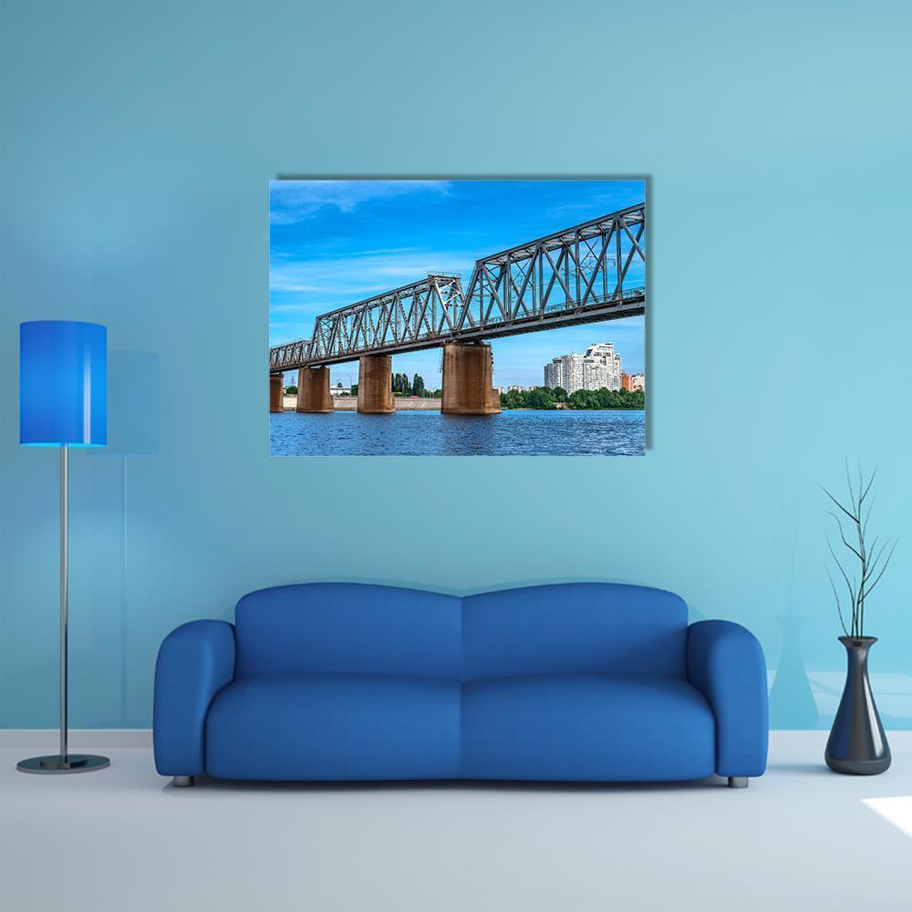 Steel Truss Railway Bridge Over the River Canvas Wall Art in gray, brown and blue, single panel hung on a wall