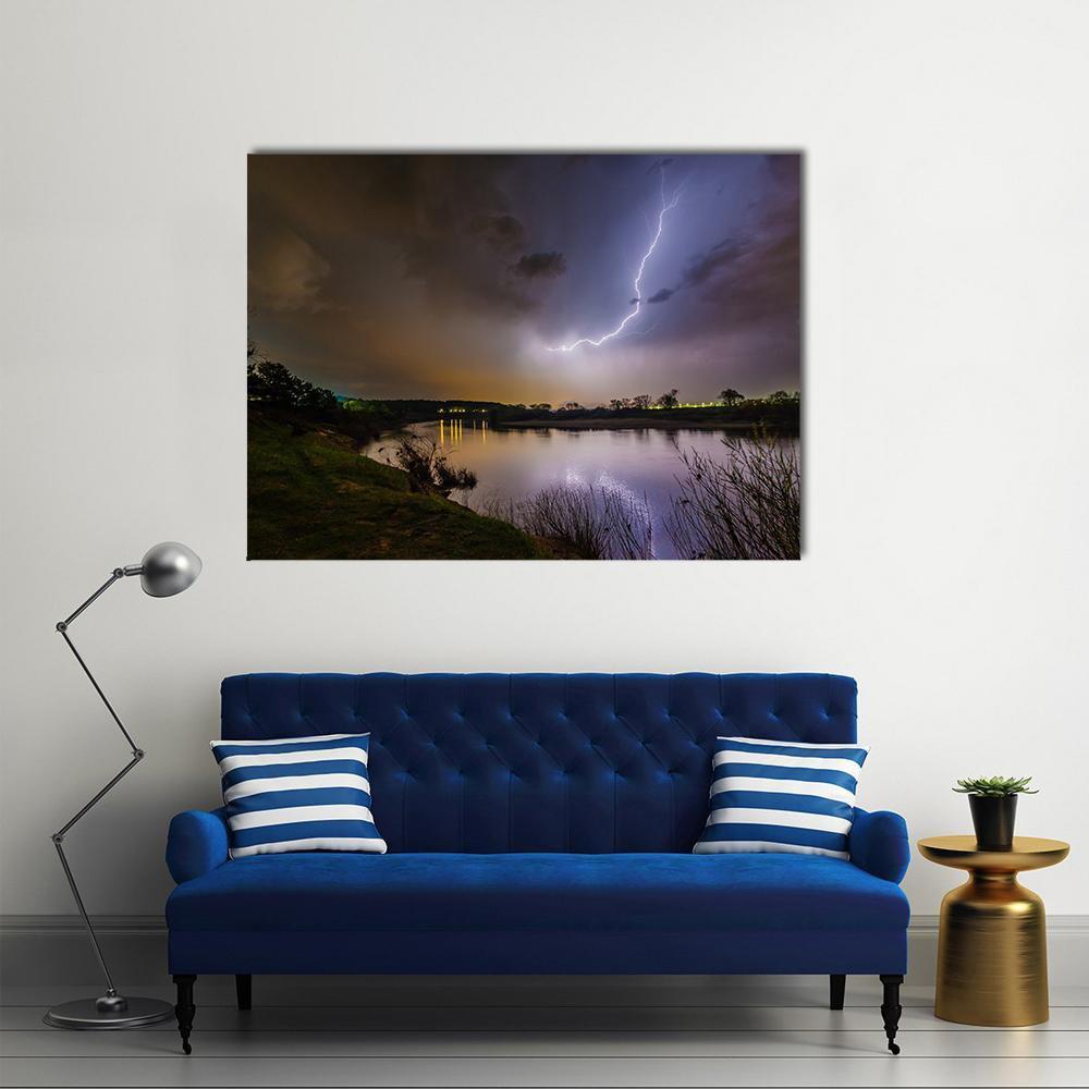 Rain and Lightning Above the River Canvas Wall Art in black, blue and purple, single panel hung on a wall