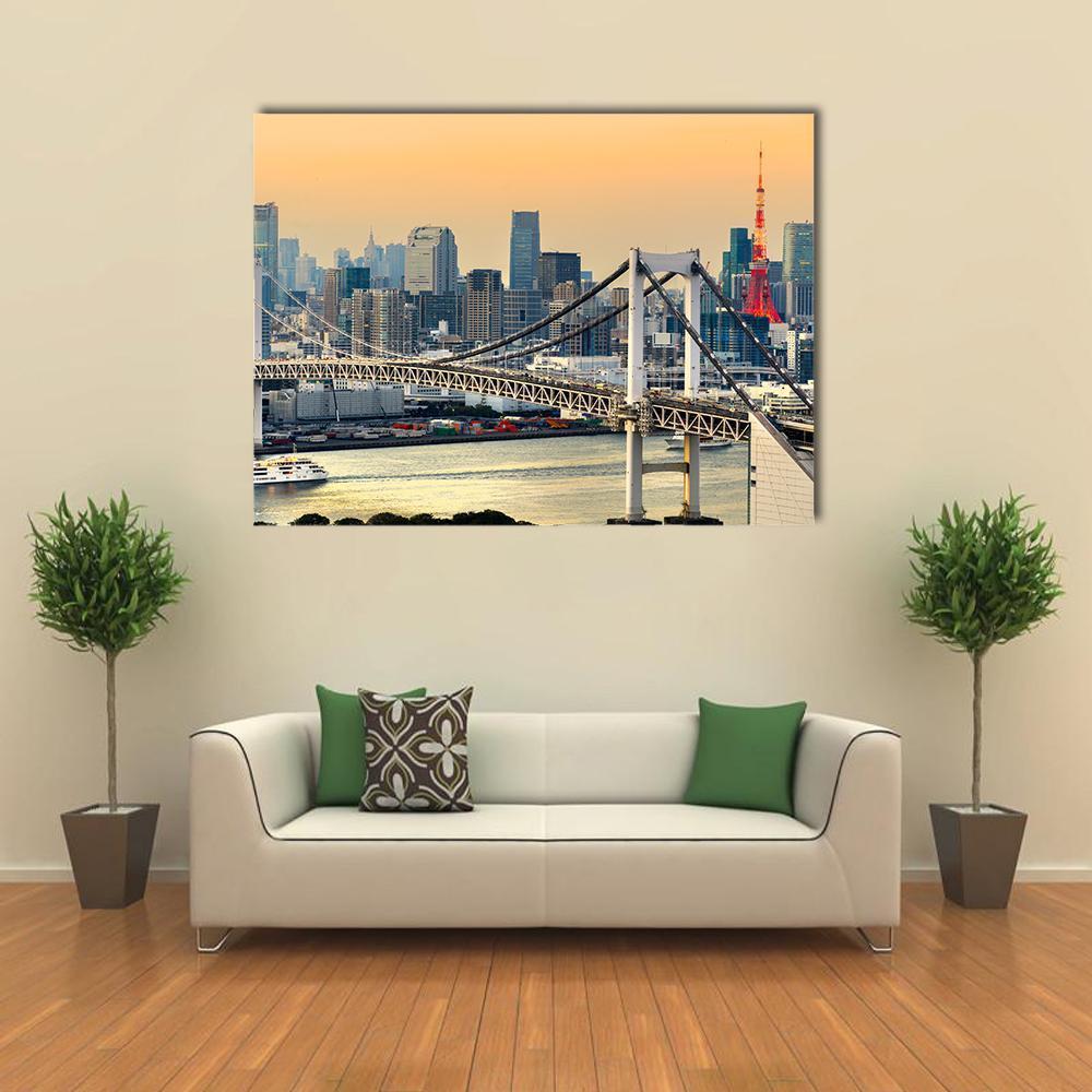 Tokyo Tower and Rainbow Bridge at Sunset Canvas Wall Art in orange, yellow and blue, single panel hung on a wall