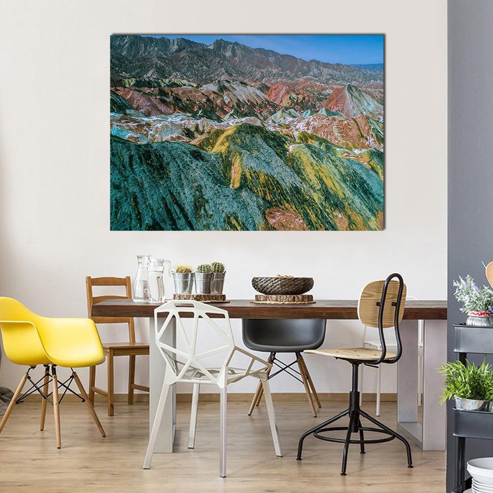 Vibrant Rainbow Mountains of Zhangye Canvas Wall Art in green, blue and multicolor, single panel hung on a wall