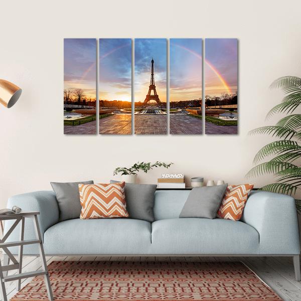 Rainbow Over Eiffel Tower Canvas Wall Art in orange, blue and multicolor, hung on a wall