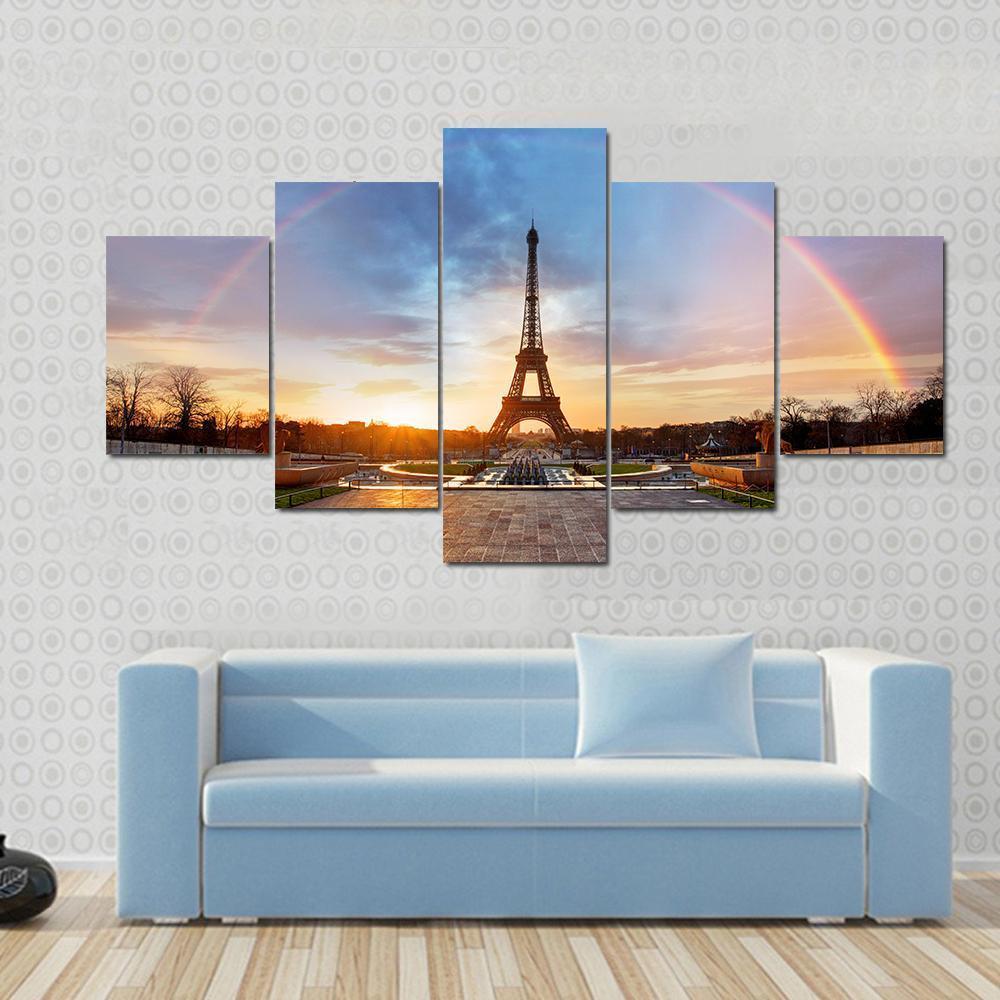 Rainbow Over Eiffel Tower Canvas Wall Art in orange, blue and multicolor, 3 panel horizontal set hung on a wall