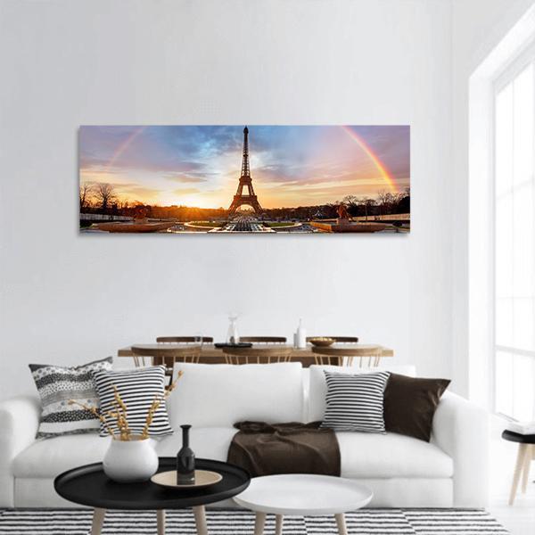 Rainbow Over Eiffel Tower at Sunset Panoramic Canvas Wall Art in orange, yellow and blue, hung on a wall