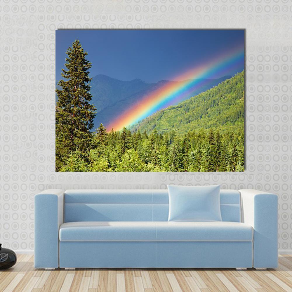 Rainbow Over Forest at Sunset Canvas Wall Art in green, blue and multicolor, single panel hung on a wall