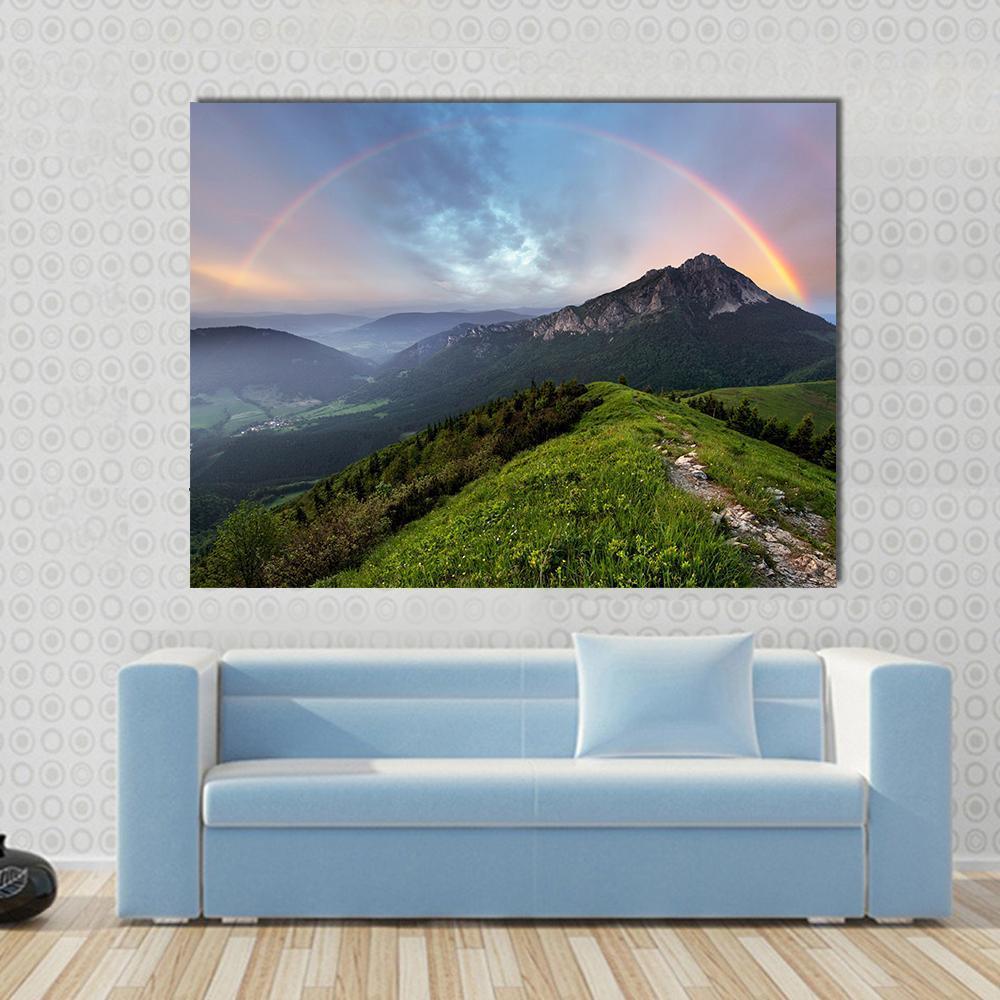 Rainbow Over Mountain Peak Canvas Wall Art in green, blue and multicolor, single panel hung on a wall