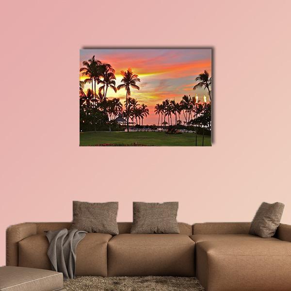 Rainbow Sunset Over Tropical Beach Canvas Wall Art in orange, green and pink, single panel hung on a wall