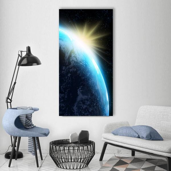 Orbital Sunrise Over Earth Vertical Canvas Wall Art in black, yellow and blue, single vertical panel hung on a wall