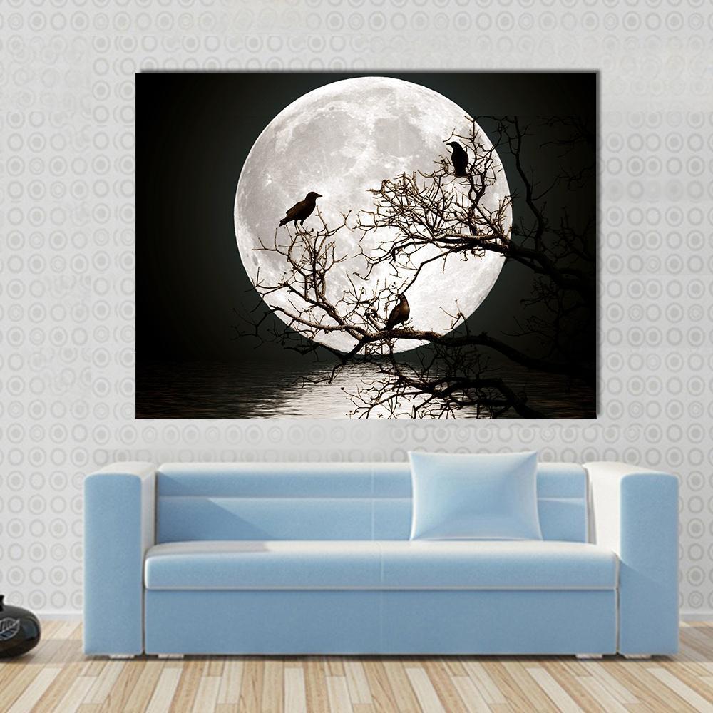 Ravens on a Tree Under the Full Moon Canvas Wall Art in black and white, single panel hung on a wall