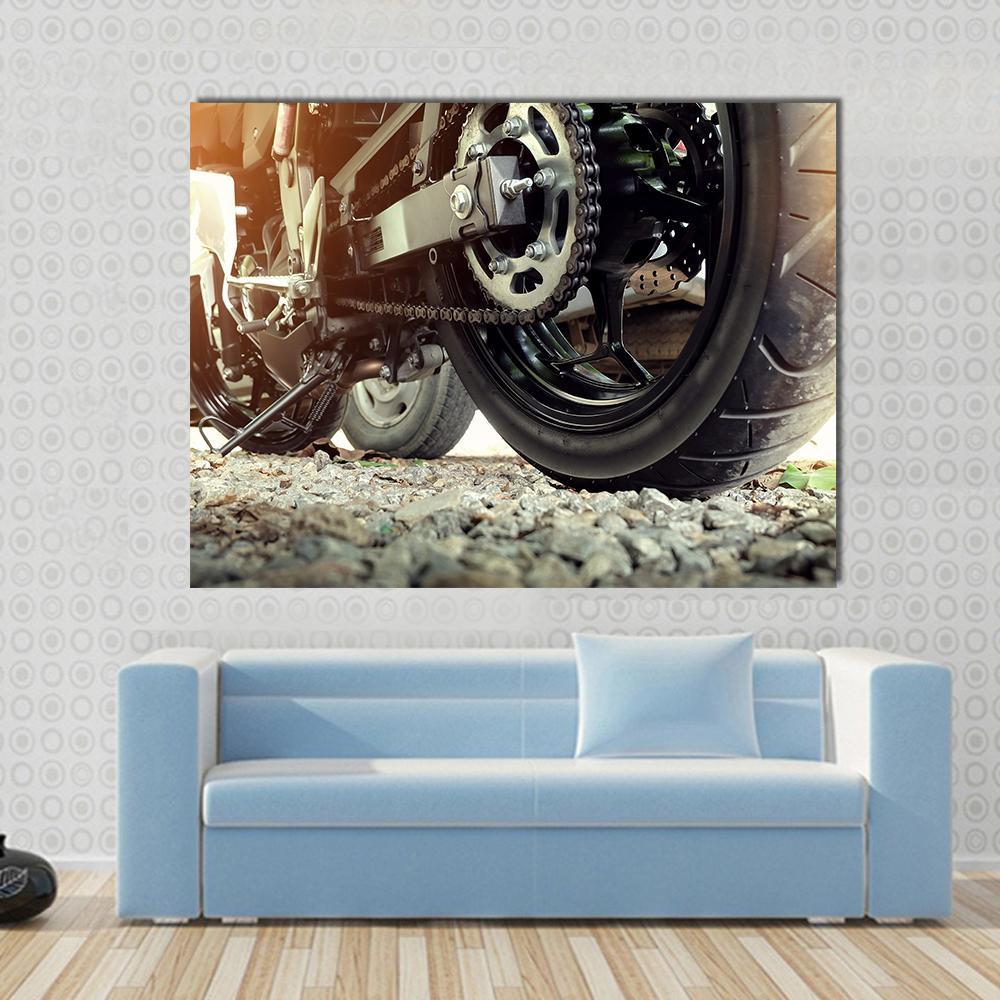 Motorcycle Rear Chain and Sprocket Canvas Wall Art in black, gray and silver, single panel hung on a wall