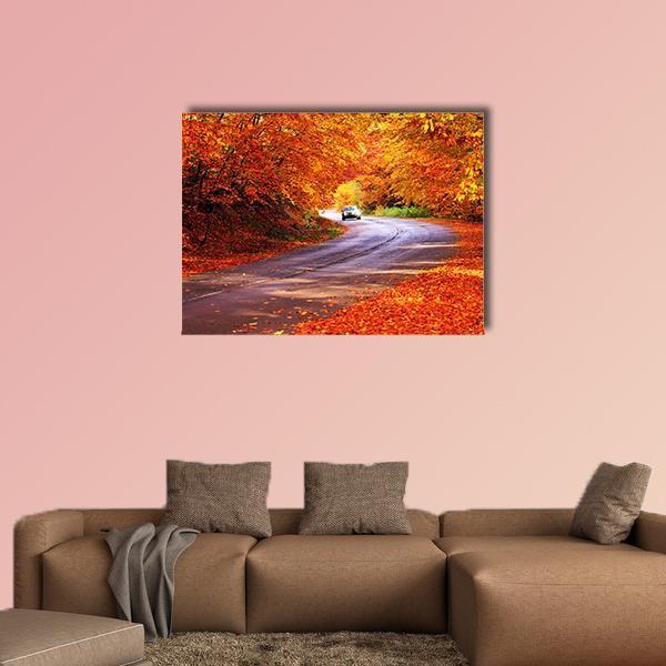 Sunny Red Autumn Road with White Car Canvas Wall Art in red, orange and yellow, single panel hung on a wall