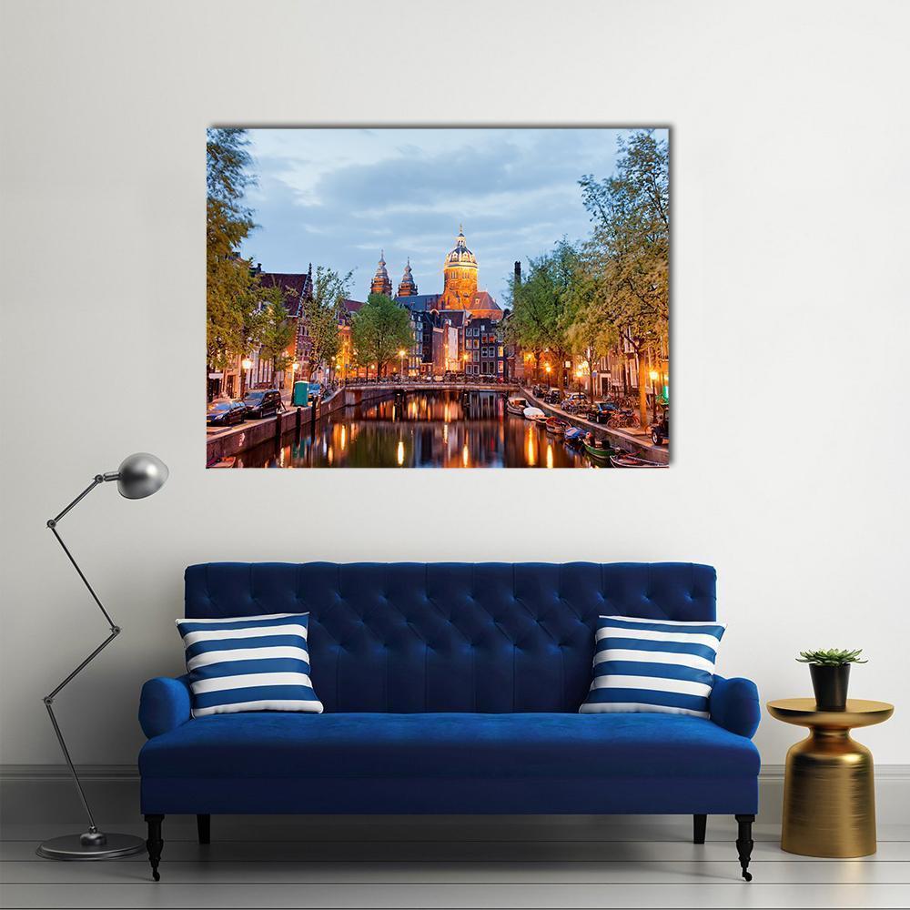 Amsterdam at Dusk Canvas Wall Art in brown, orange and blue, single panel hung on a wall