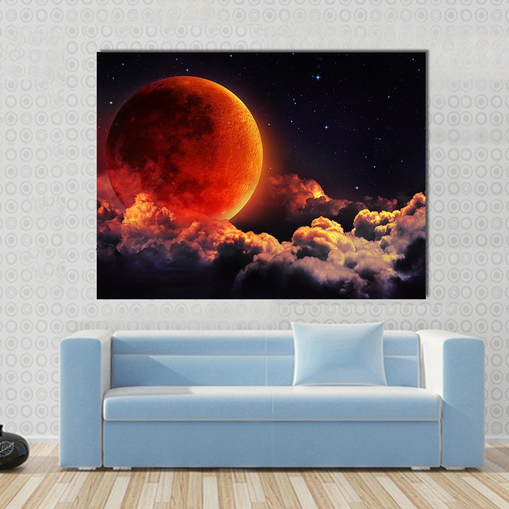 Red Moon with Glowing Clouds Canvas Wall Art in black, red and orange, single panel hung on a wall