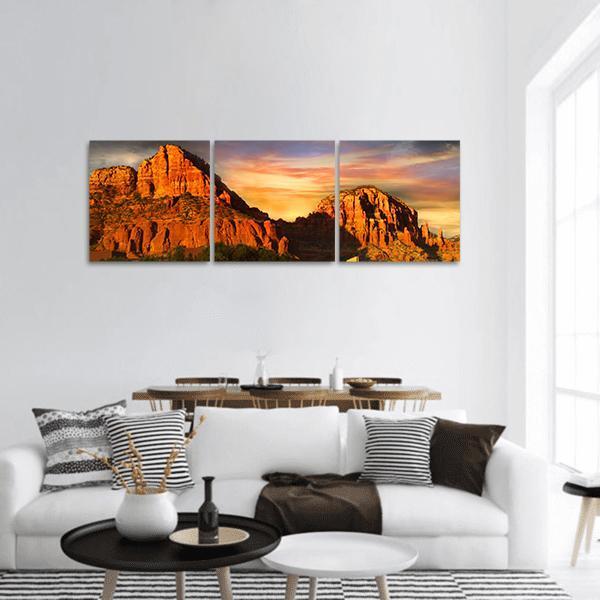 Sedona Red Rock Mountains at Sunset Panoramic Canvas Wall Art in red, orange and yellow, hung on a wall