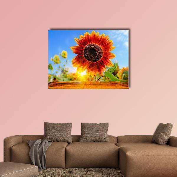 Red Sunflowers with Sunrise Flare Canvas Wall Art in red, orange and blue, single panel hung on a wall