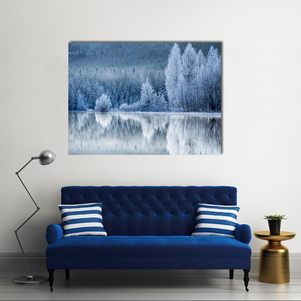 Forest Reflection on Frozen Lake Canvas Wall Art in white, gray and blue, single panel hung on a wall