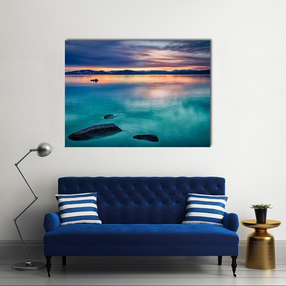 Cloud Reflections on Snow-capped Mountain Lake Canvas Wall Art in blue, navy and pink, single panel hung on a wall