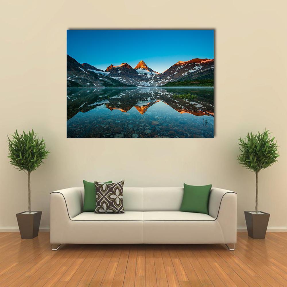Reflection of Mount Assiniboine Canvas Wall Art in brown and blue, single panel hung on a wall