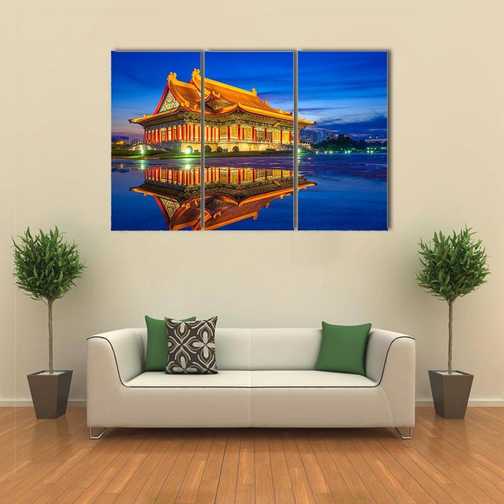 Reflection of National Theater Hall at Night Canvas Wall Art in orange, yellow and blue, 3 panel horizontal set hung on a wall