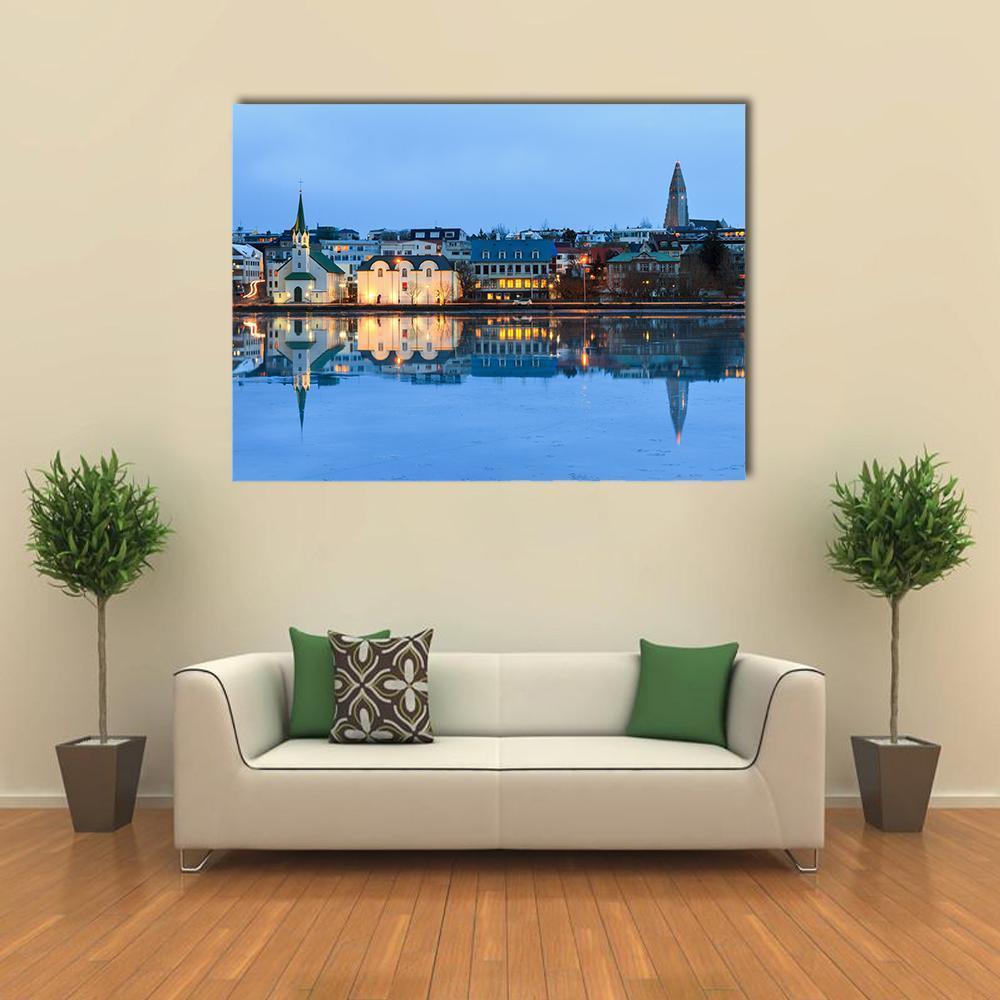Reykjavik Reflection at Dusk Canvas Wall Art in white, yellow and blue, single panel hung on a wall