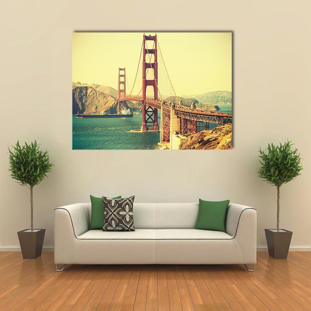 Retro Golden Gate Bridge Canvas Wall Art in orange, yellow and blue, single panel hung on a wall