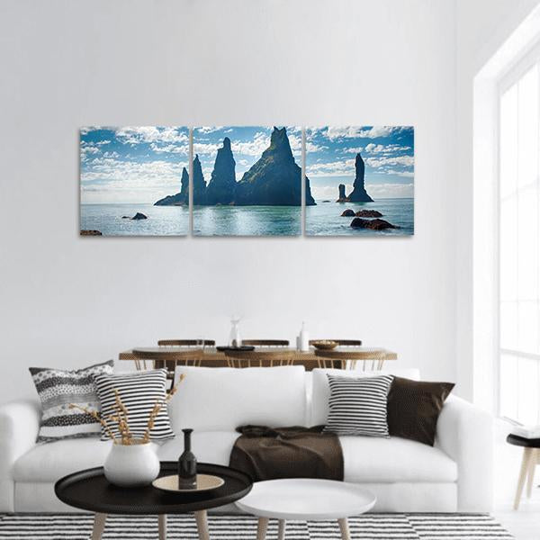 Reynisdrangar Sea Stacks Near Vik, Iceland Panoramic Canvas Wall Art in black, white and blue, hung on a wall