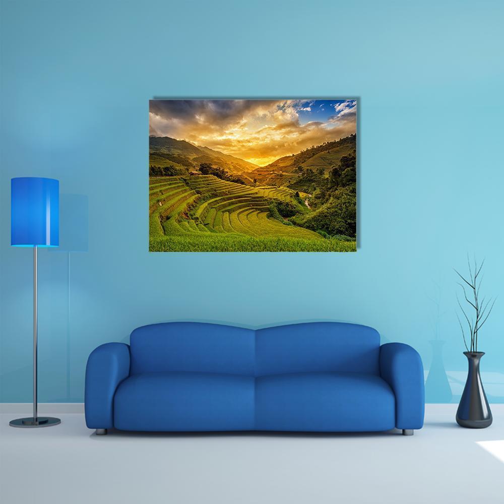 Sunset Over Terraced Rice Fields Canvas Wall Art in orange, yellow and green, single panel hung on a wall