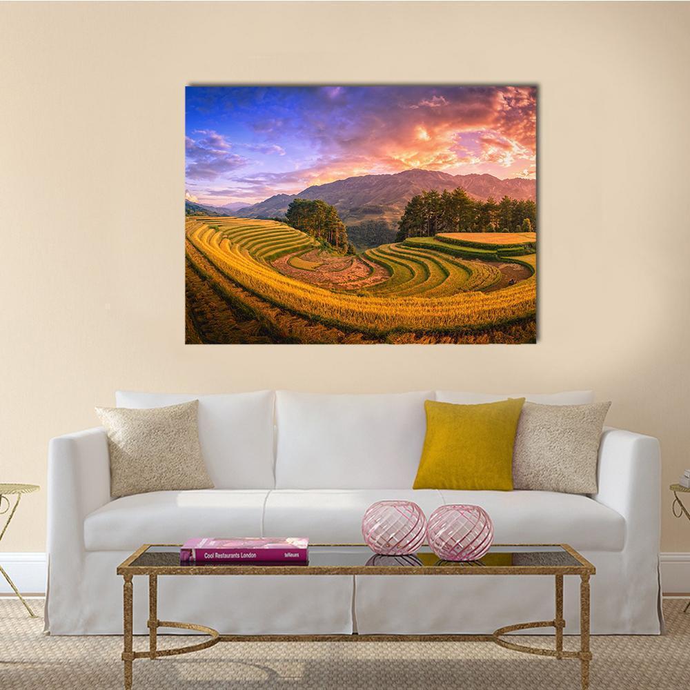 Terraced Rice Fields with Coniferous Trees at Sunset Canvas Wall Art in orange, yellow and blue, single panel hung on a wall