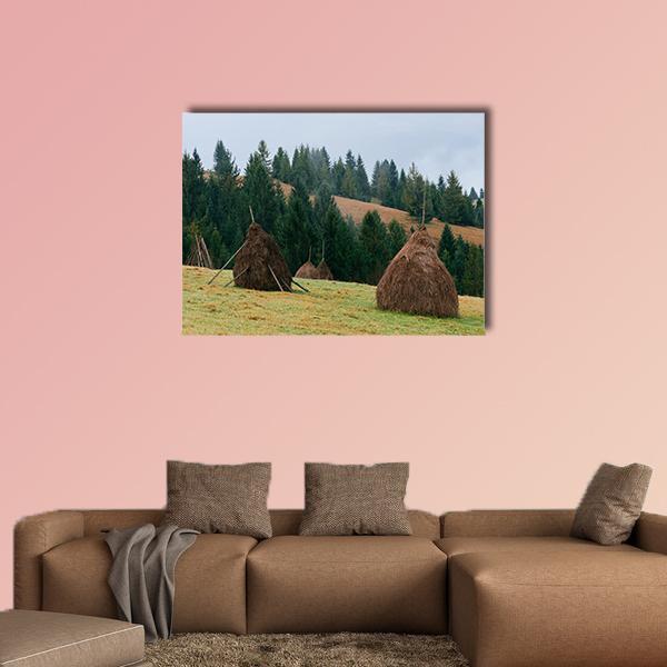 Three Haystacks in Autumn Field Canvas Wall Art in beige, brown and green, single panel hung on a wall