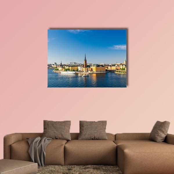Riddarholm Church Near Lake Malaren Canvas Wall Art in orange, yellow and blue, single panel hung on a wall