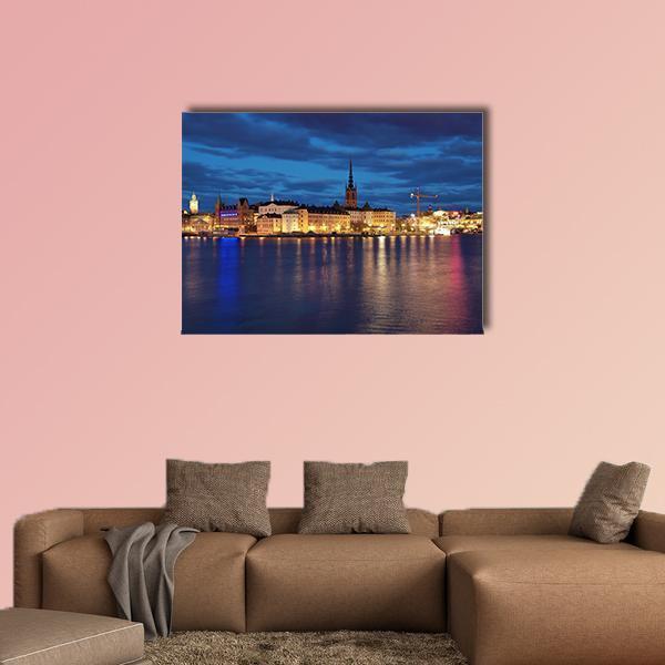 Riddarholmen and Gamla Stan at Night Canvas Wall Art in yellow, blue and navy, single panel hung on a wall
