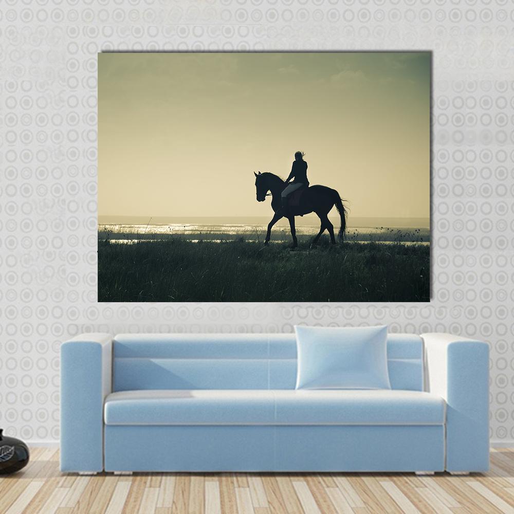 Rider Silhouette on Horseback Canvas Wall Art in black, beige and yellow, single panel hung on a wall