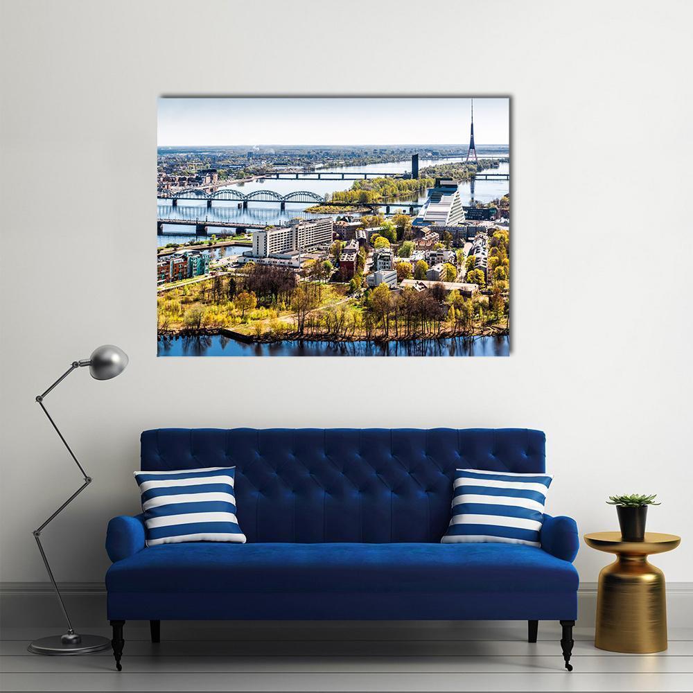 Riga Aerial Cityscape with River and Bridges Canvas Wall Art in yellow, green and blue, single panel hung on a wall