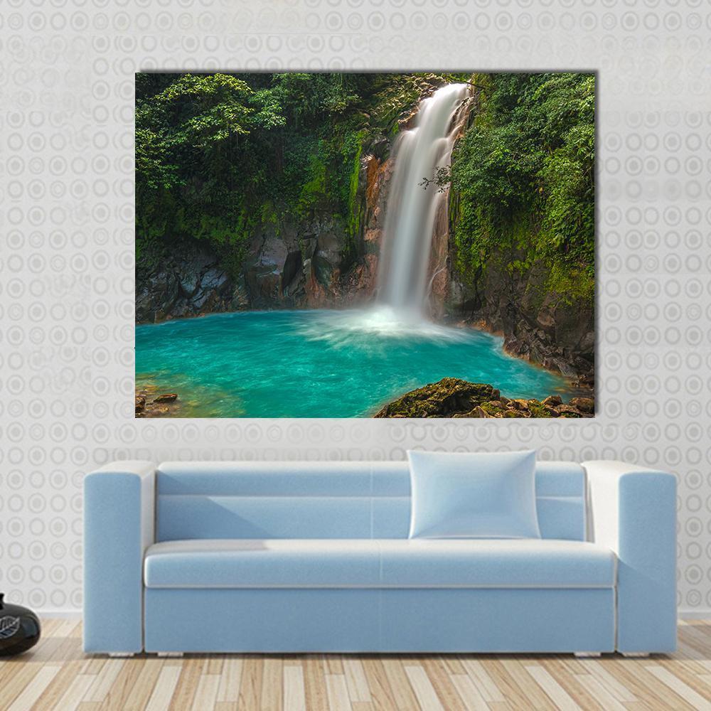 Rio Celeste Waterfall Costa Rica Canvas Wall Art in brown, green and blue, single panel hung on a wall