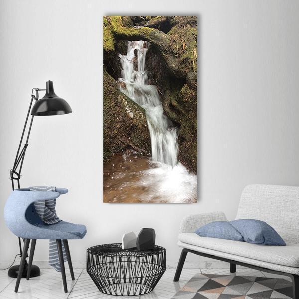 River Bach Waterfall Vertical Canvas Wall Art in white, brown and green, single vertical panel hung on a wall