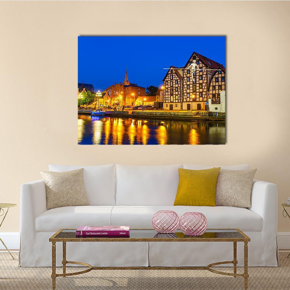 River Brda at Night with Granaries Canvas Wall Art in orange, yellow and blue, single panel hung on a wall