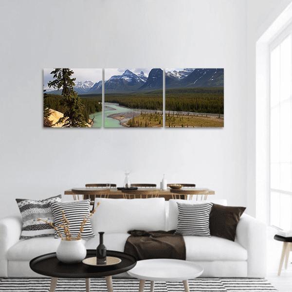 River at Foot of Canadian Rockies Panoramic Canvas Wall Art in gray, green and blue, hung on a wall