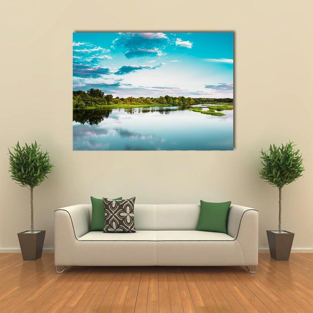 River with Lush Green Trees Canvas Wall Art in green and blue, single panel hung on a wall