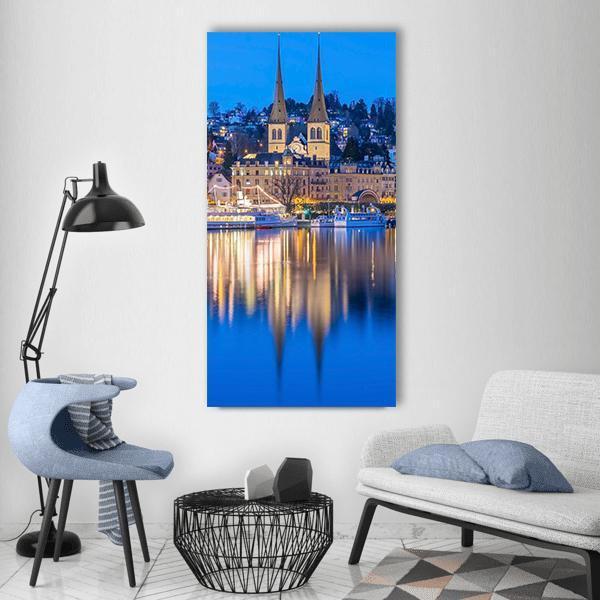 St. Leodegar on the River Reuss, Lucerne Vertical Canvas Wall Art in gold, yellow and blue, single vertical panel hung on a wall