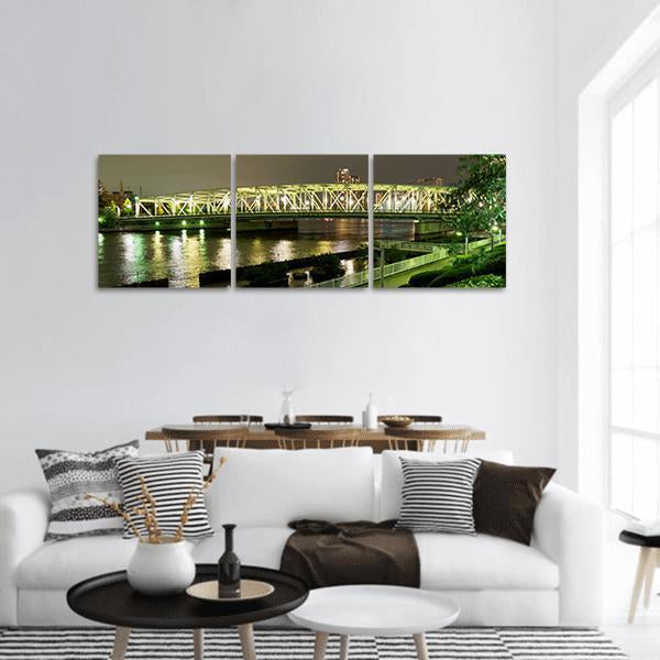 Riverside Promenade in Japan Panoramic Canvas Wall Art in black, yellow and green, hung on a wall