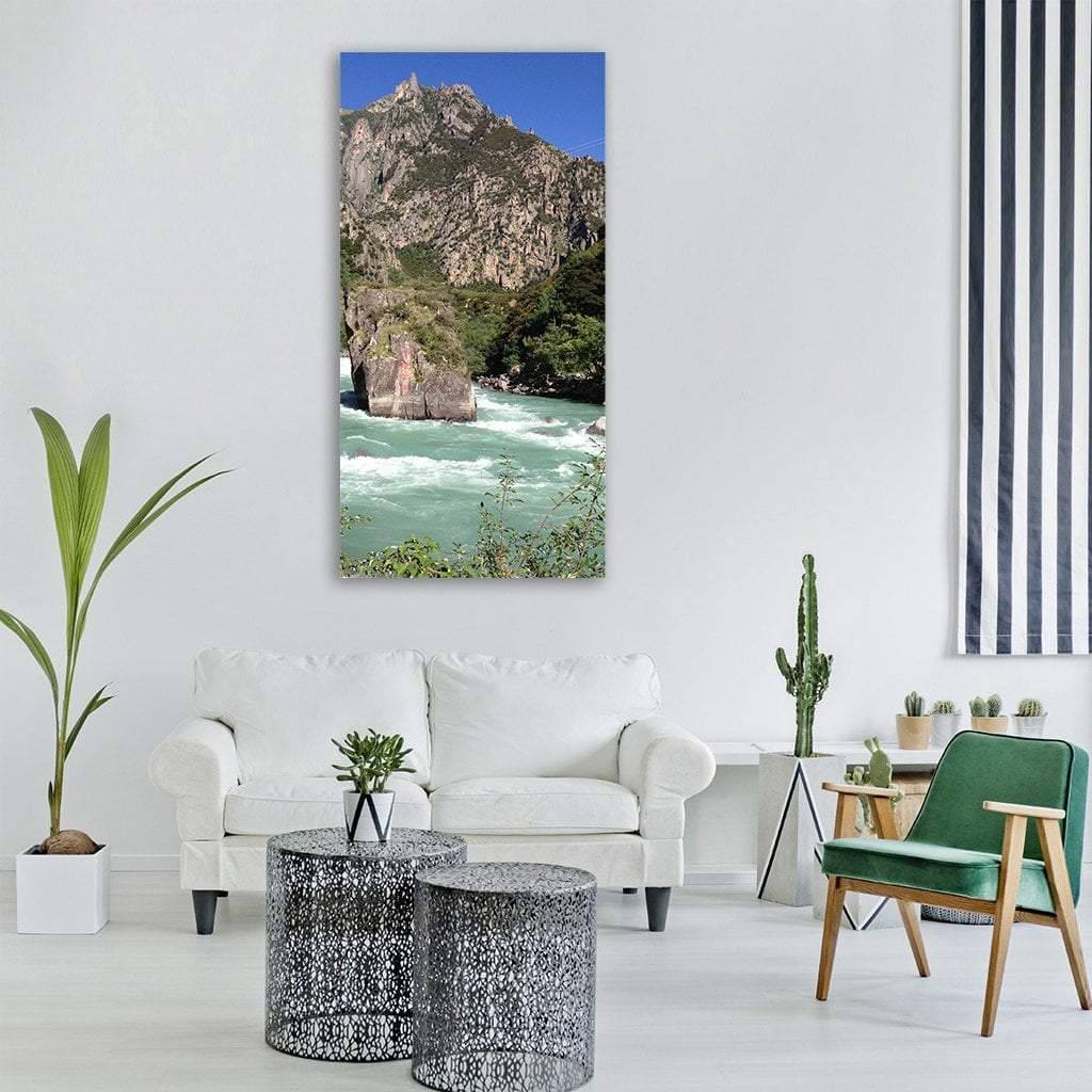 Turquoise Mountain River with Rapids Vertical Canvas Wall Art in gray, green and blue, single vertical panel hung on a wall
