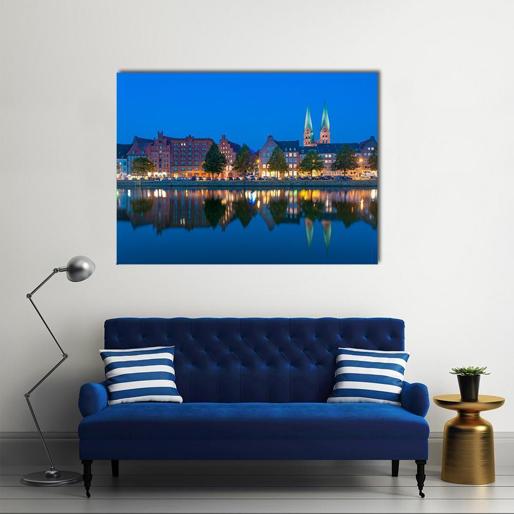 Historic Waterfront with Twin Church Spires Canvas Wall Art in brown, orange and blue, single panel hung on a wall