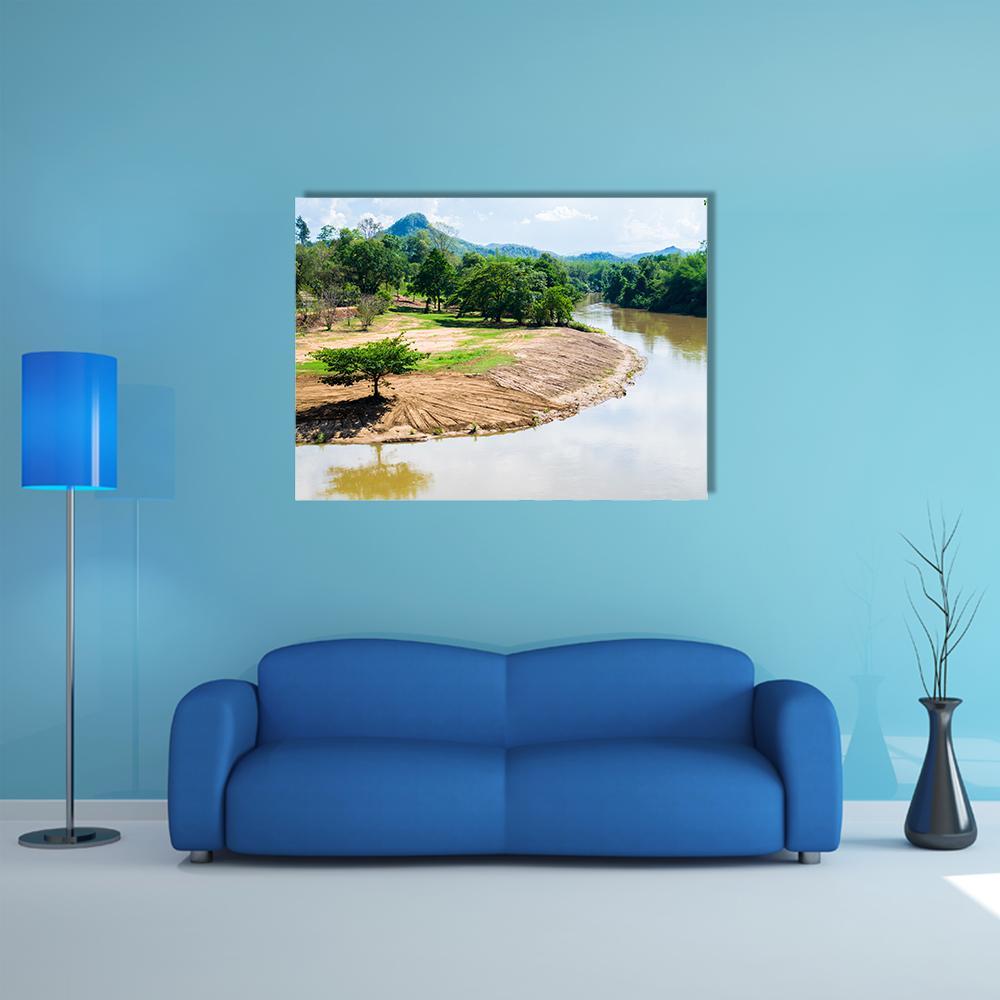 River Bend with Mountain Reflection Canvas Wall Art in brown, green and blue, single panel hung on a wall