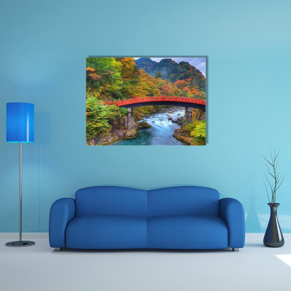 Shinkyo Bridge Over Autumn River Canvas Wall Art in red, green and blue, single panel hung on a wall